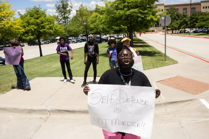 McKINNEY - TEXAS - JUNE 6: Karmelo Anthony's extended family member Michael Wilson, front, of Fort Worth and other supporters of Anthony chant outside of the Collin County Courthouse as Anthony's murder trial is underway in McKinney, TX, Saturday, June 6, 2026. Anthony is accused of killing 17-year-old Austin Metcalf last April at a Frisco track meet at David Kuykendall Stadium. (Juan Figueroa/The Dallas Morning News via Getty Images)