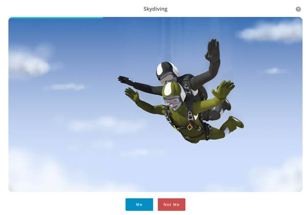 Two people tandem skydiving through a cloudy sky, wearing helmets and jumpsuits